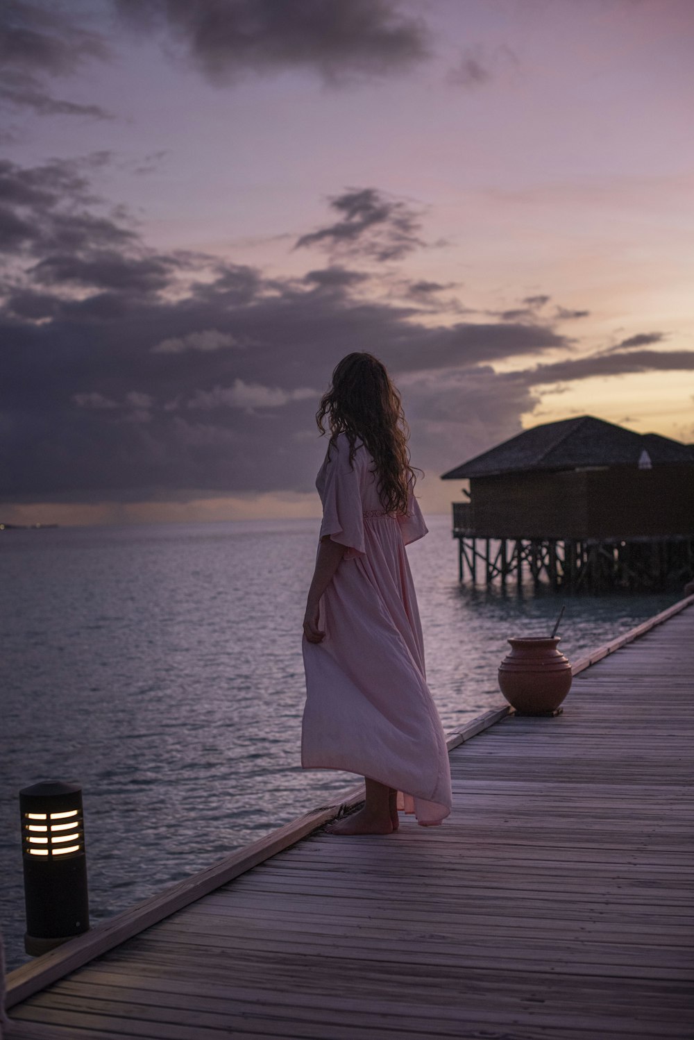 woman stands on dock