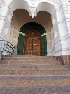 Renovated entrance with decorative stamped concrete steps and matching walkway.