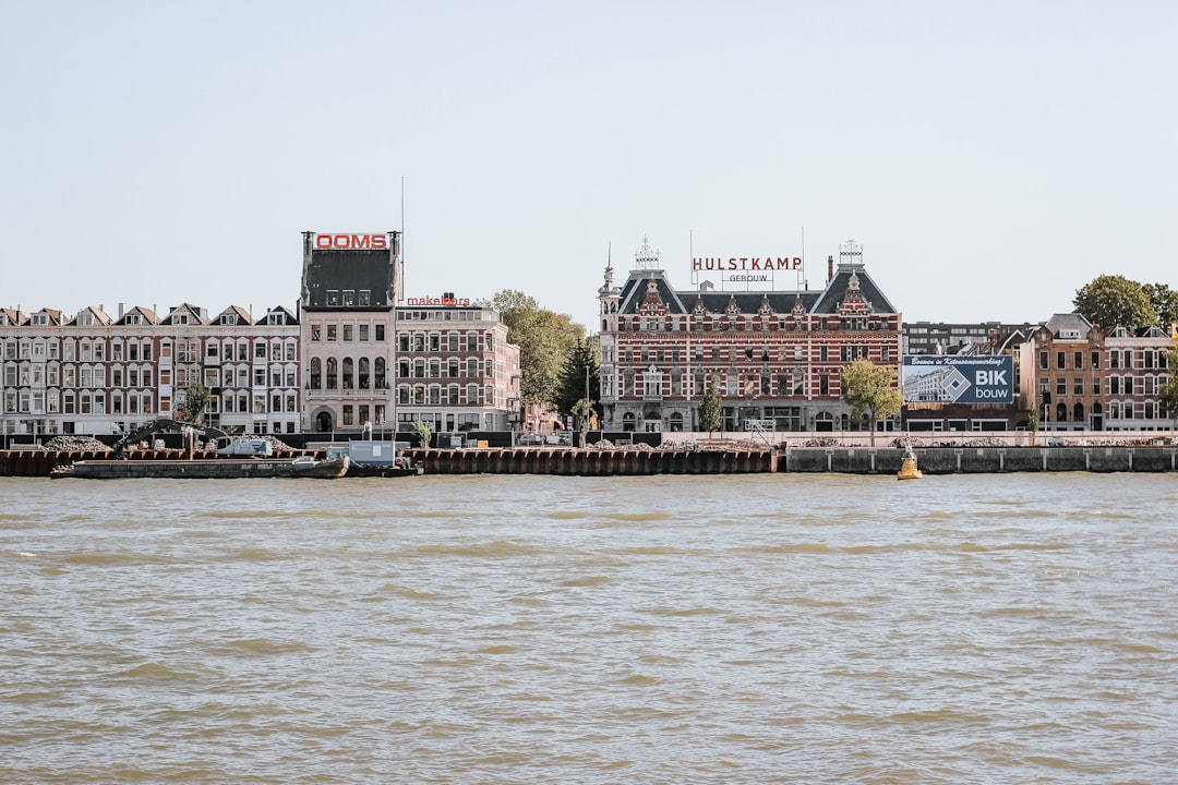 brown concrete buildings near body of water