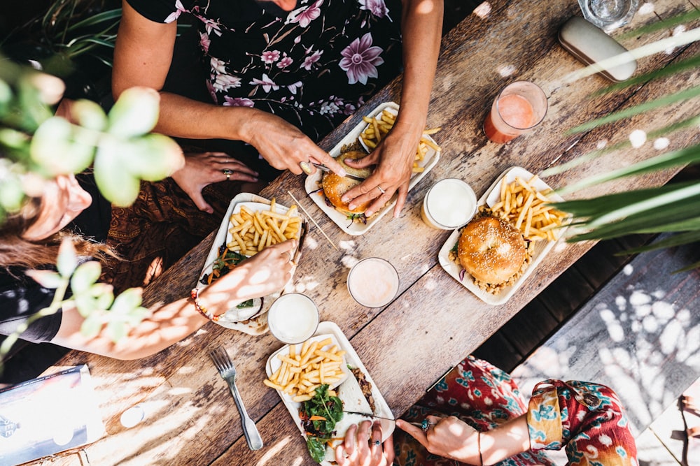 woman slicing burger into half