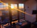 A cozy mountain-view room at sunset with warm lighting inside.