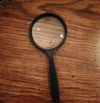 black framed magnifying glass