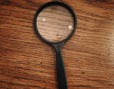 black framed magnifying glass