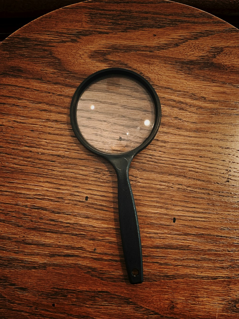 black framed magnifying glass