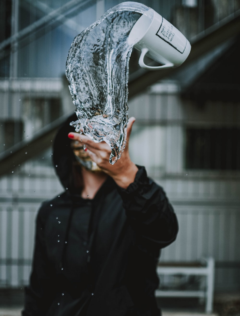 person throw mug with water