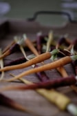 Colorful assortment of organic carrots and radishes on a wooden table.