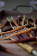 Colorful assortment of carrots and cabbage displayed on a wooden table.