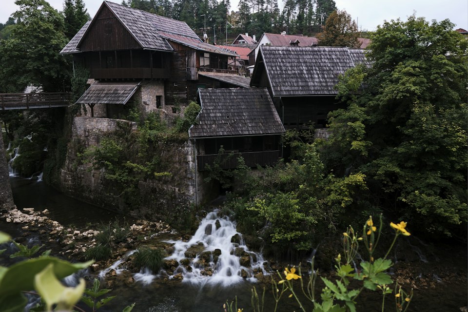 Old wooden watermill houses above a small waterfall in Rastoke village, Croatia