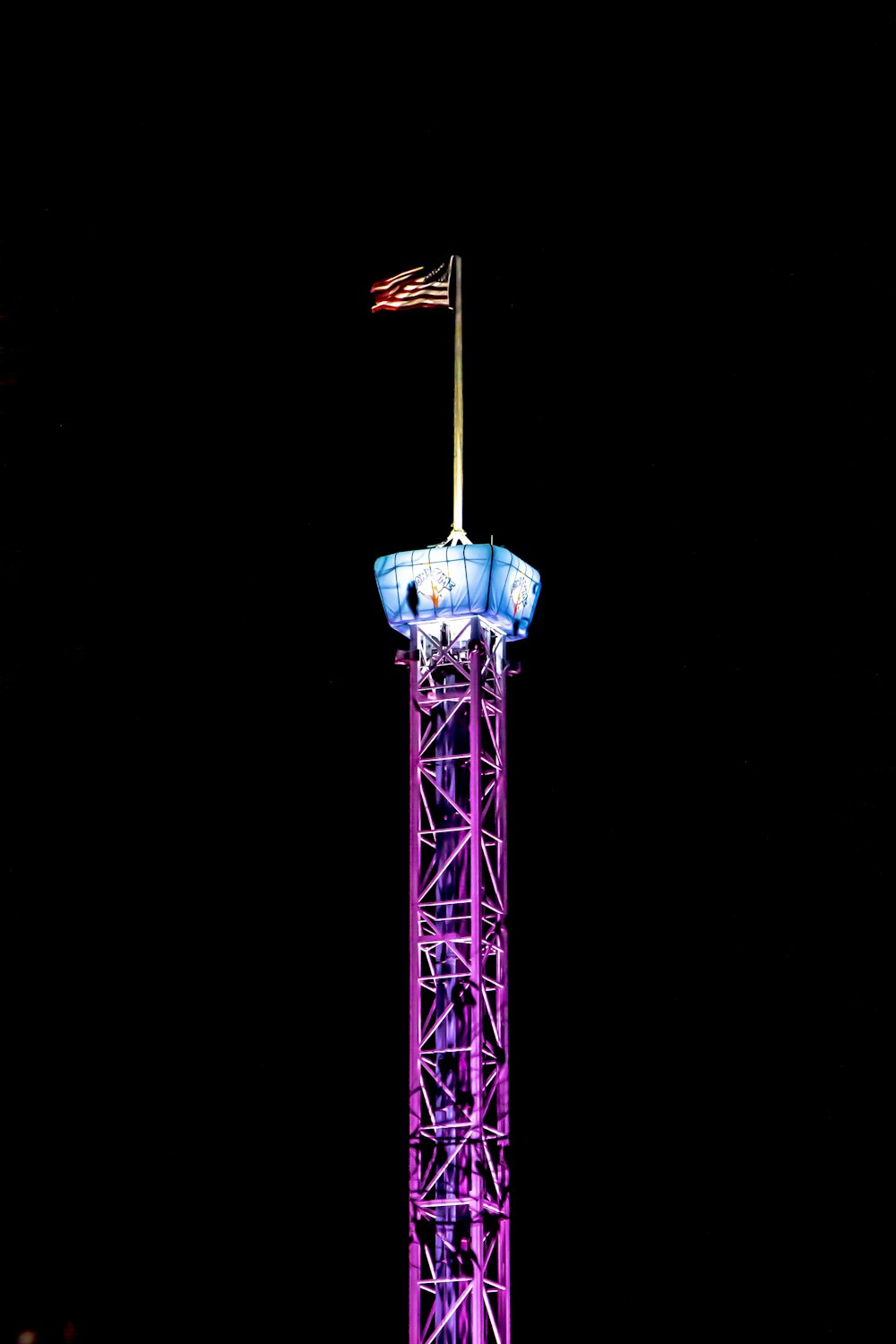 purple and blue tower with American flag on top