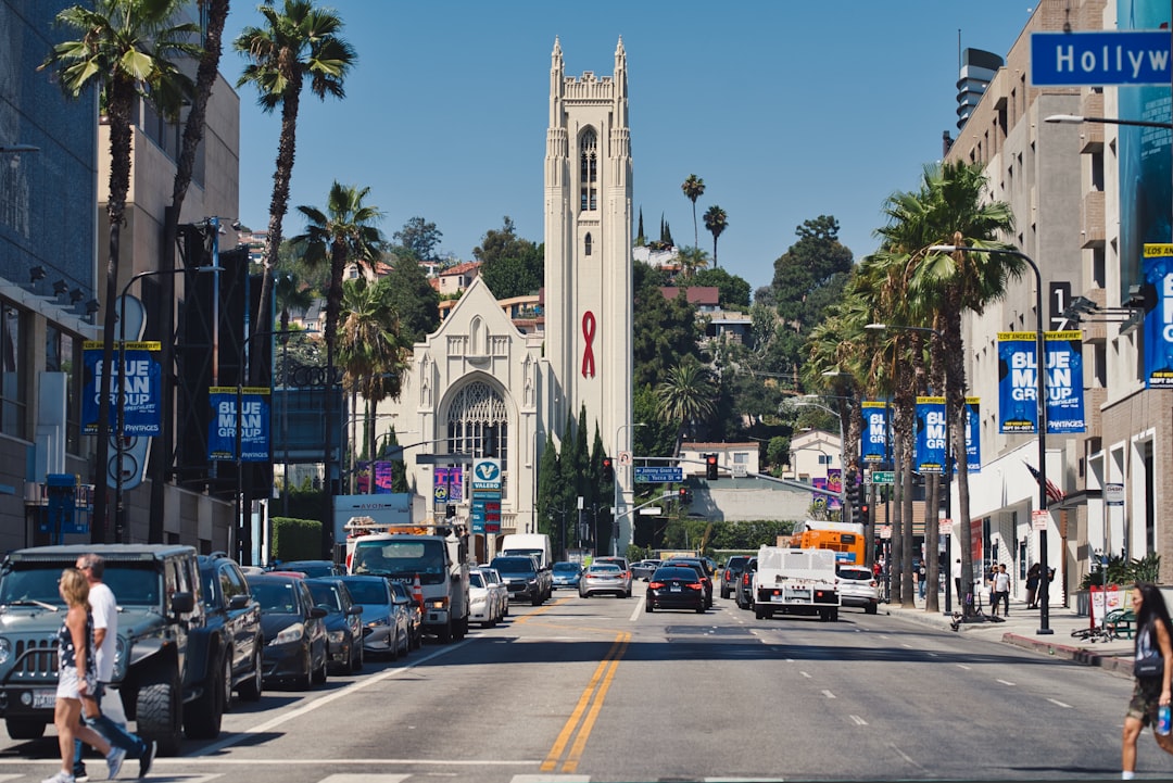a city street filled with lots of traffic next to tall buildings,