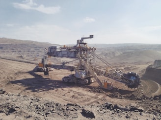 gray heavy equipment on vast land during daytime
