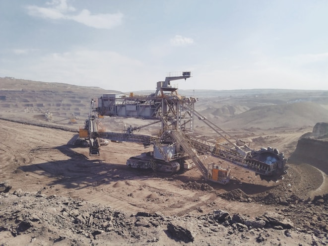 gray heavy equipment on vast land during daytime