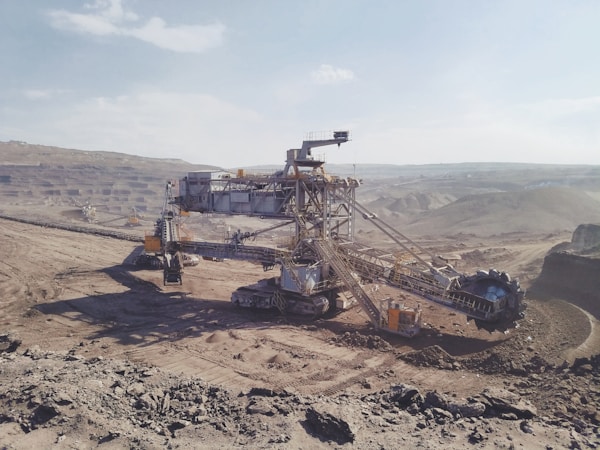 gray heavy equipment on vast land during daytime