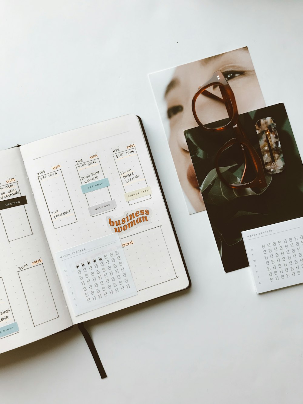 white book and brown framed eyeglasses