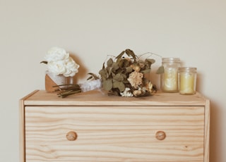 two glass jars on dresser