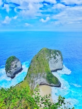 green covered island under blue sky