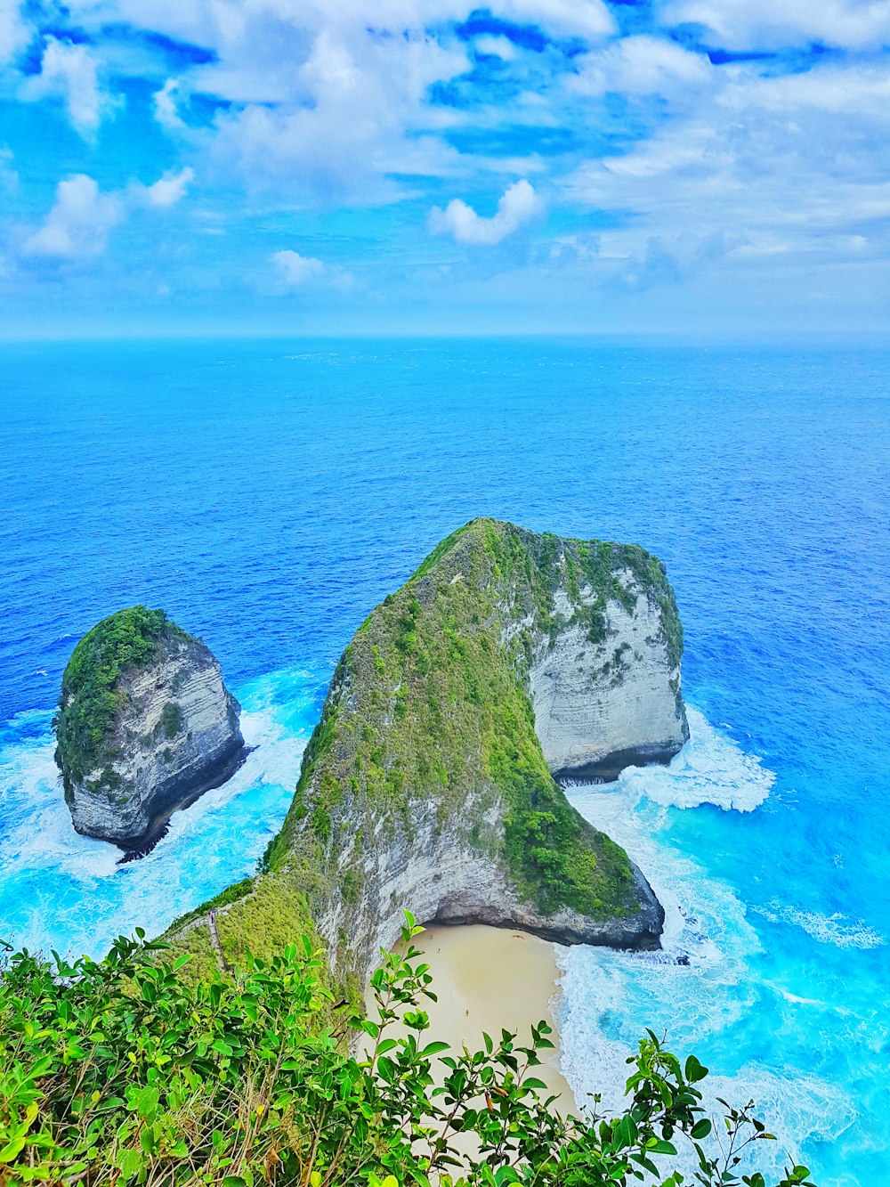 green covered island under blue sky