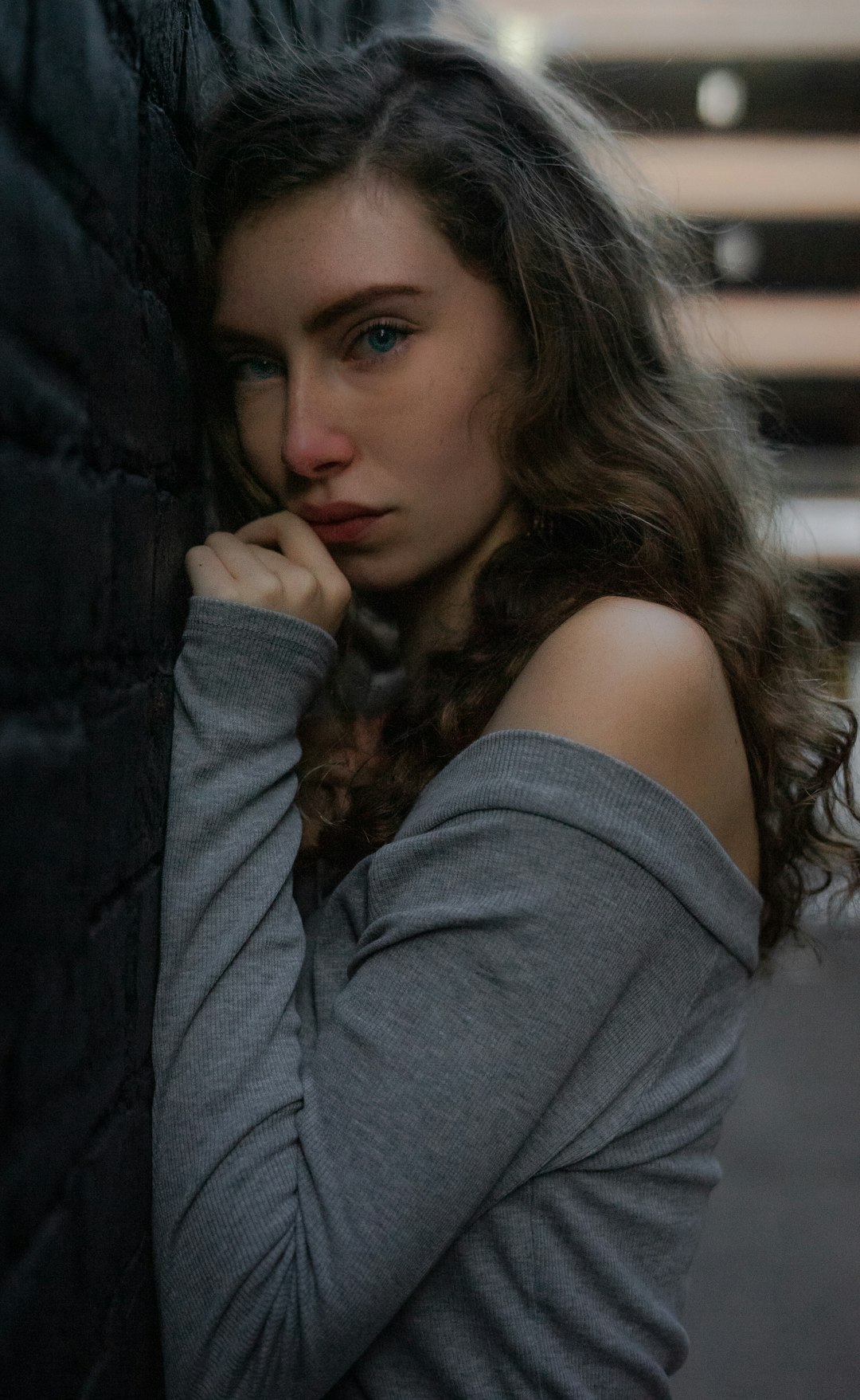 woman leaning on wall