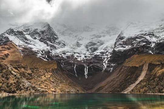 body of water near snow-covered mountain in Mountain Machu Picchu Peru