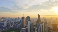 A panoramic view of a bustling city skyline at sunset, symbolizing growth and partnership.