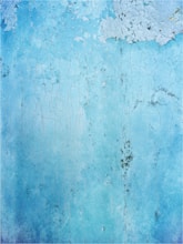a blue wall with peeling paint on it