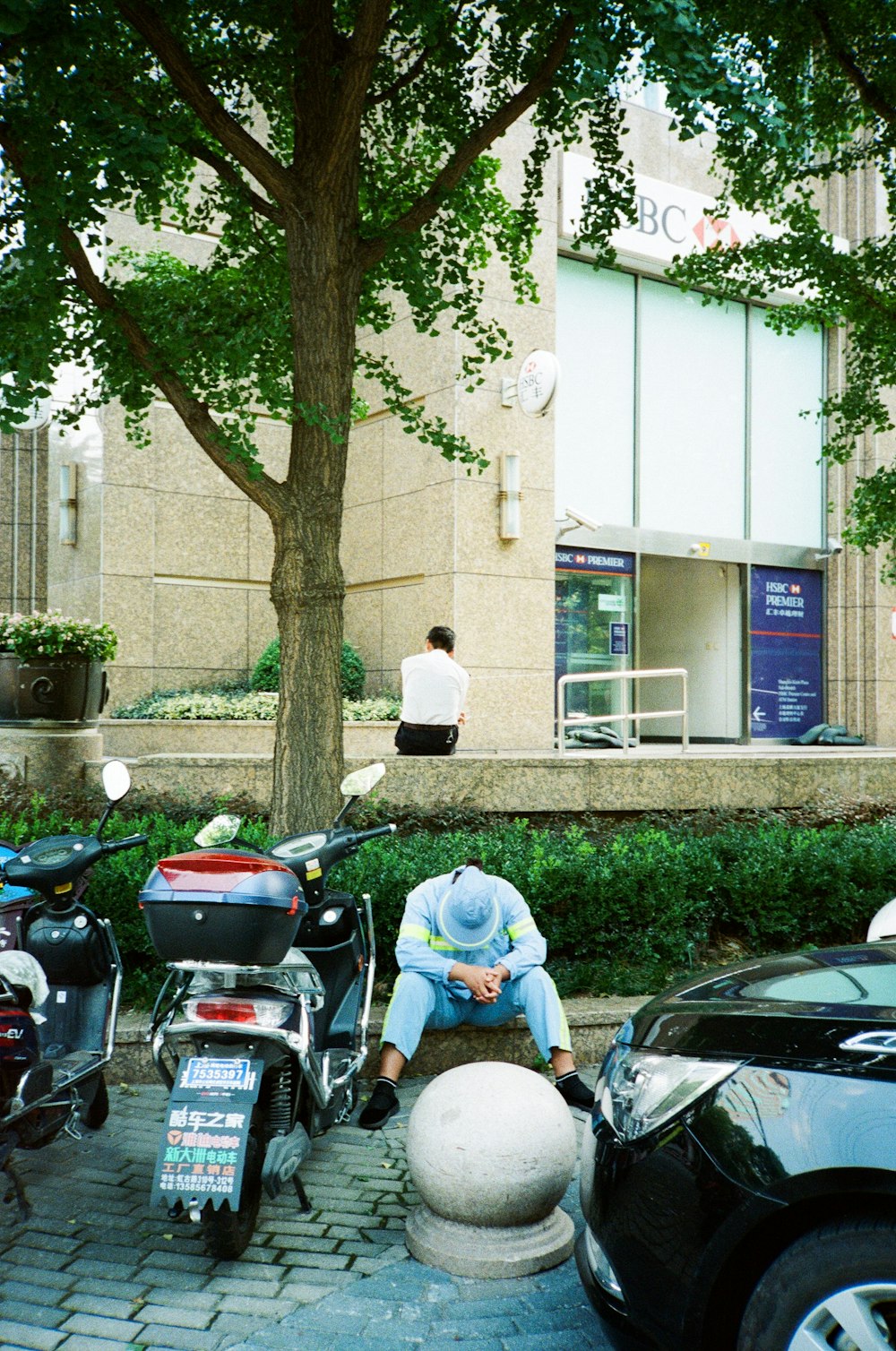 person sitting beside motorcycle