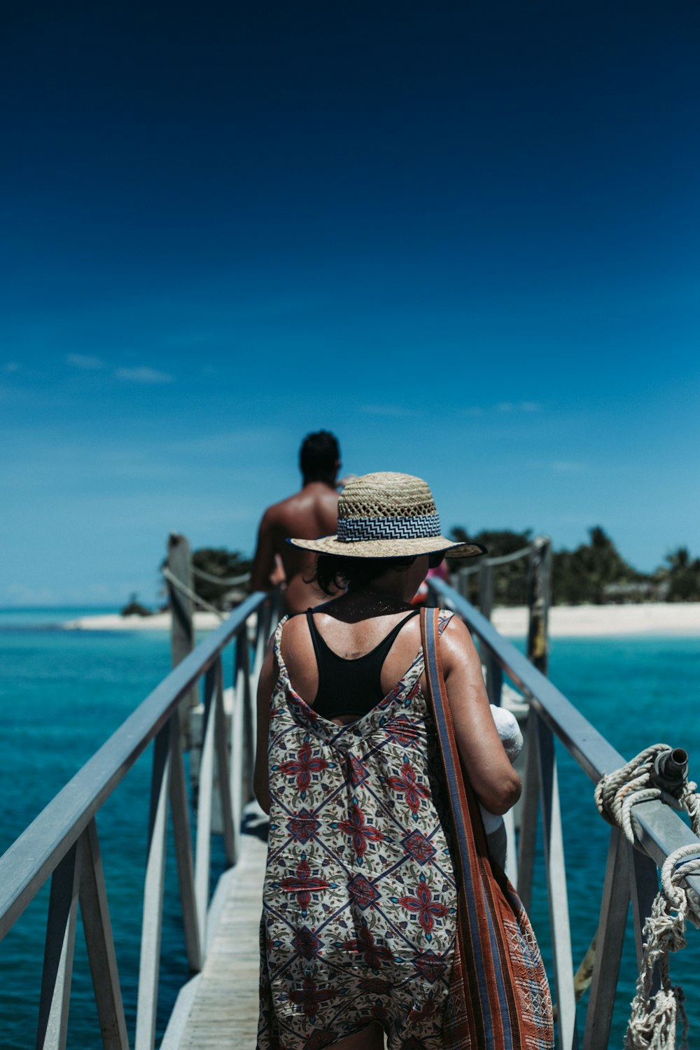 woman walking on dock during daytime