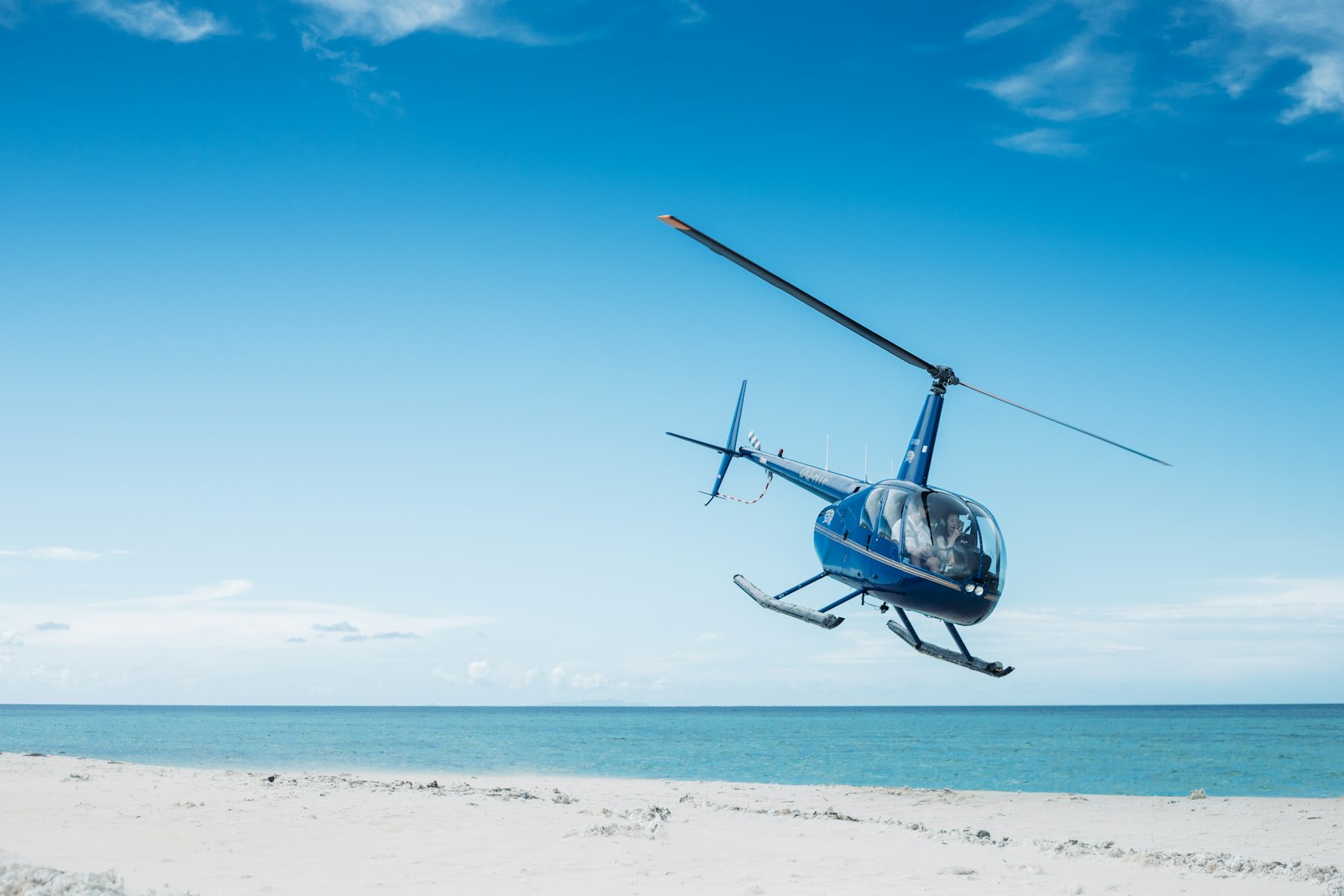 Canon EOS 6D Mark II + Canon EF 50mm F1.8 II sample photo. Blue helicopter flying on photography