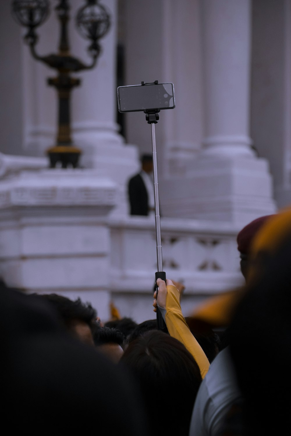 person holding gray monopod