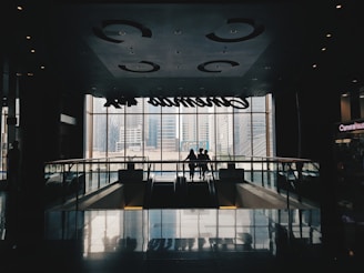 a couple of people standing in front of a window