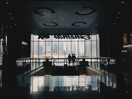 a couple of people standing in front of a window
