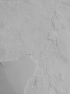 a snowboarder is going down a snowy hill