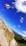 A colorful national flag waves prominently against a bright blue sky with fluffy white clouds. The scene features a rocky cliffside and expansive mountain range, highlighting rugged and lush green valleys below.