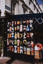 A vibrant street scene featuring colorful French posters and lively conversations.
