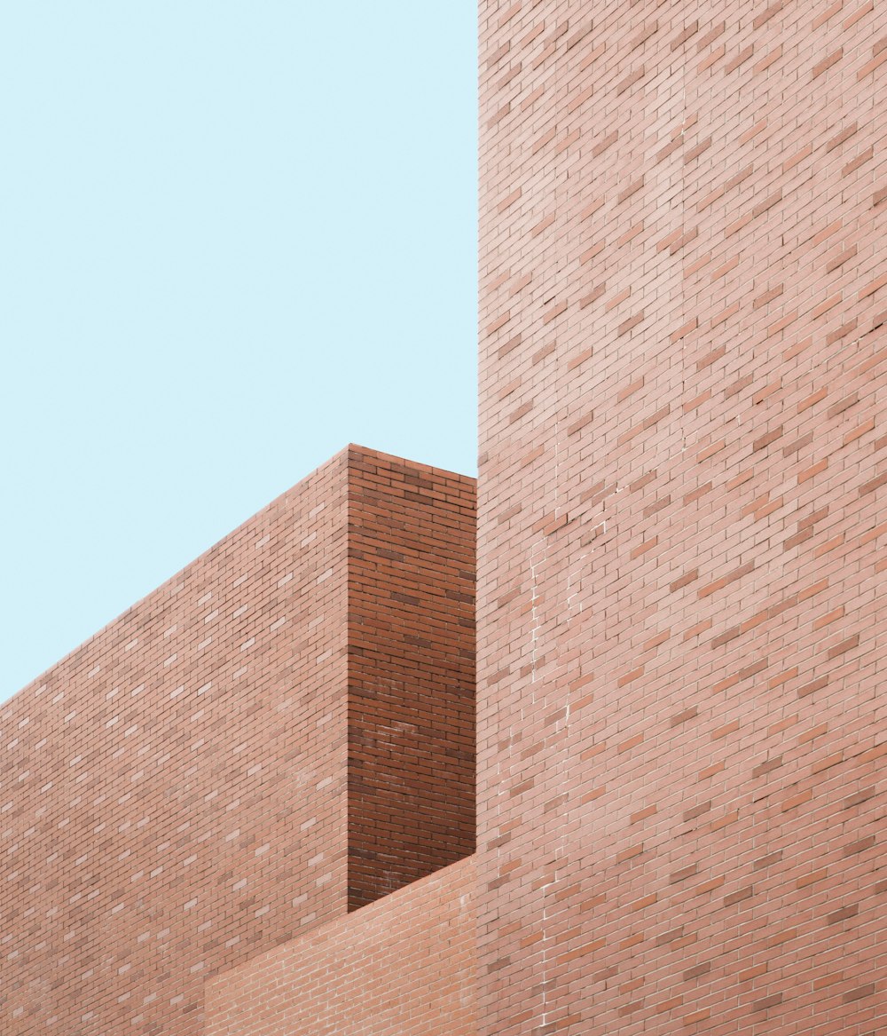 a red stop sign on the side of a brick building