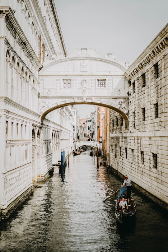 body of water between buildings at daytime in Bridge of Sighs Italy