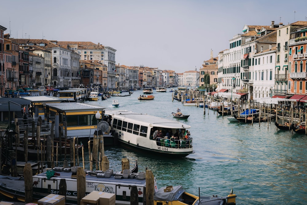 boats in body of water between buildings