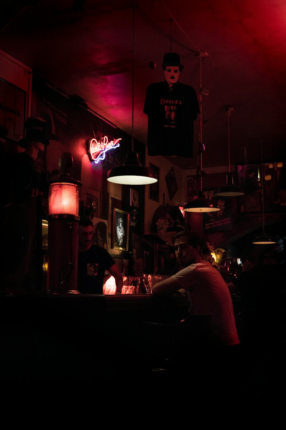 a man sitting at a bar in a dark room