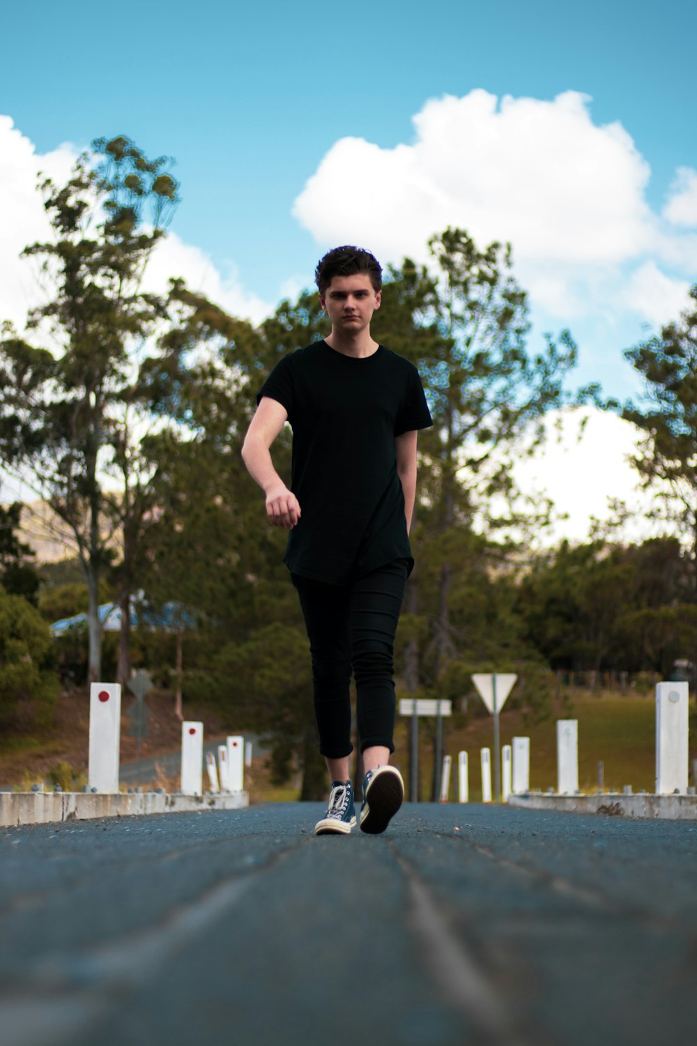 standing man wearing black crew-neck t-shirt