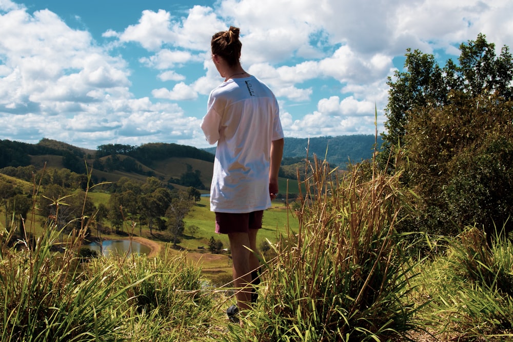 standing man wearing white t-shirt