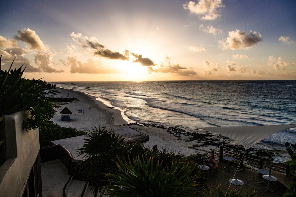 high-angle photography of blue beach under blue sky