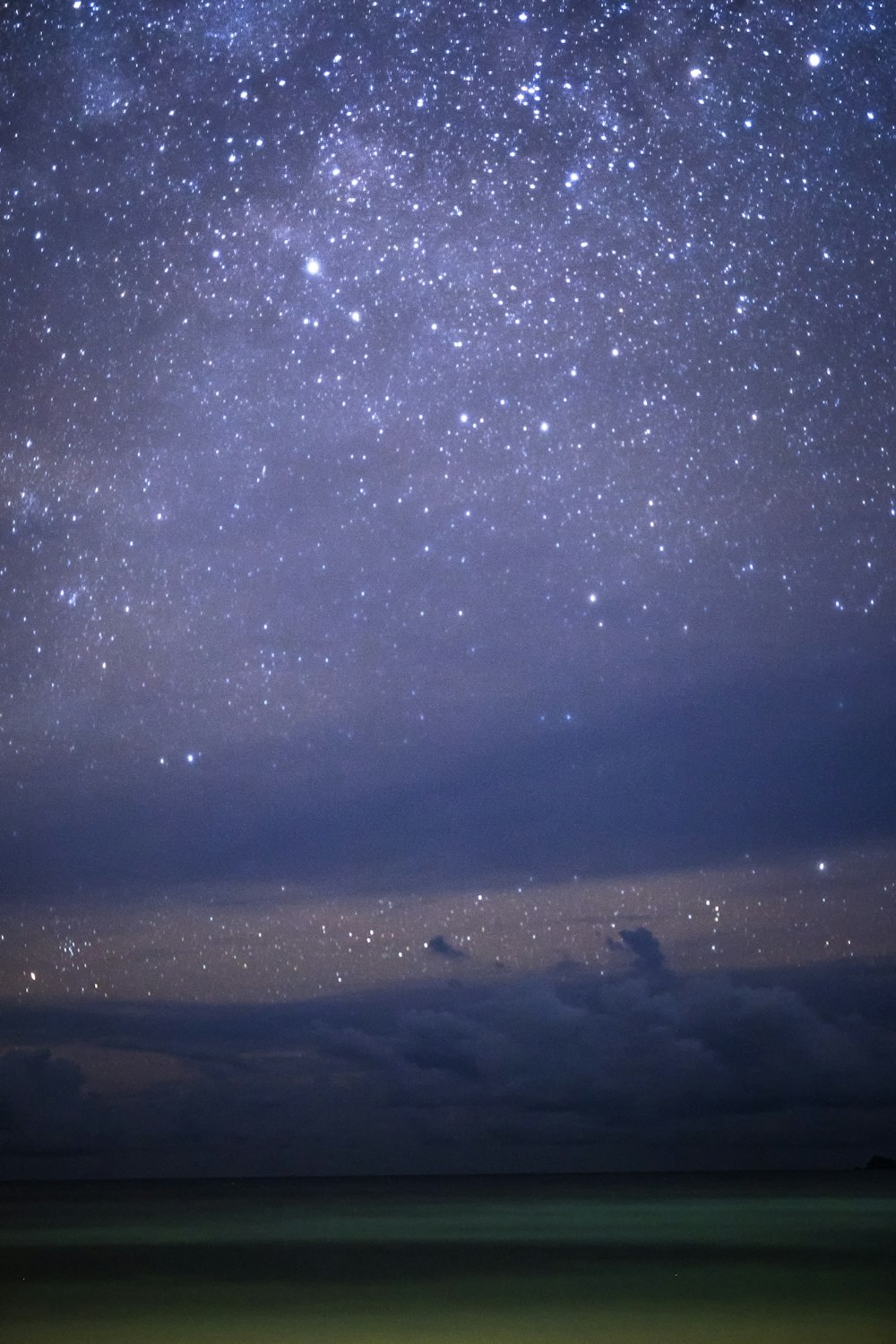 silhouette of mountains under starry night