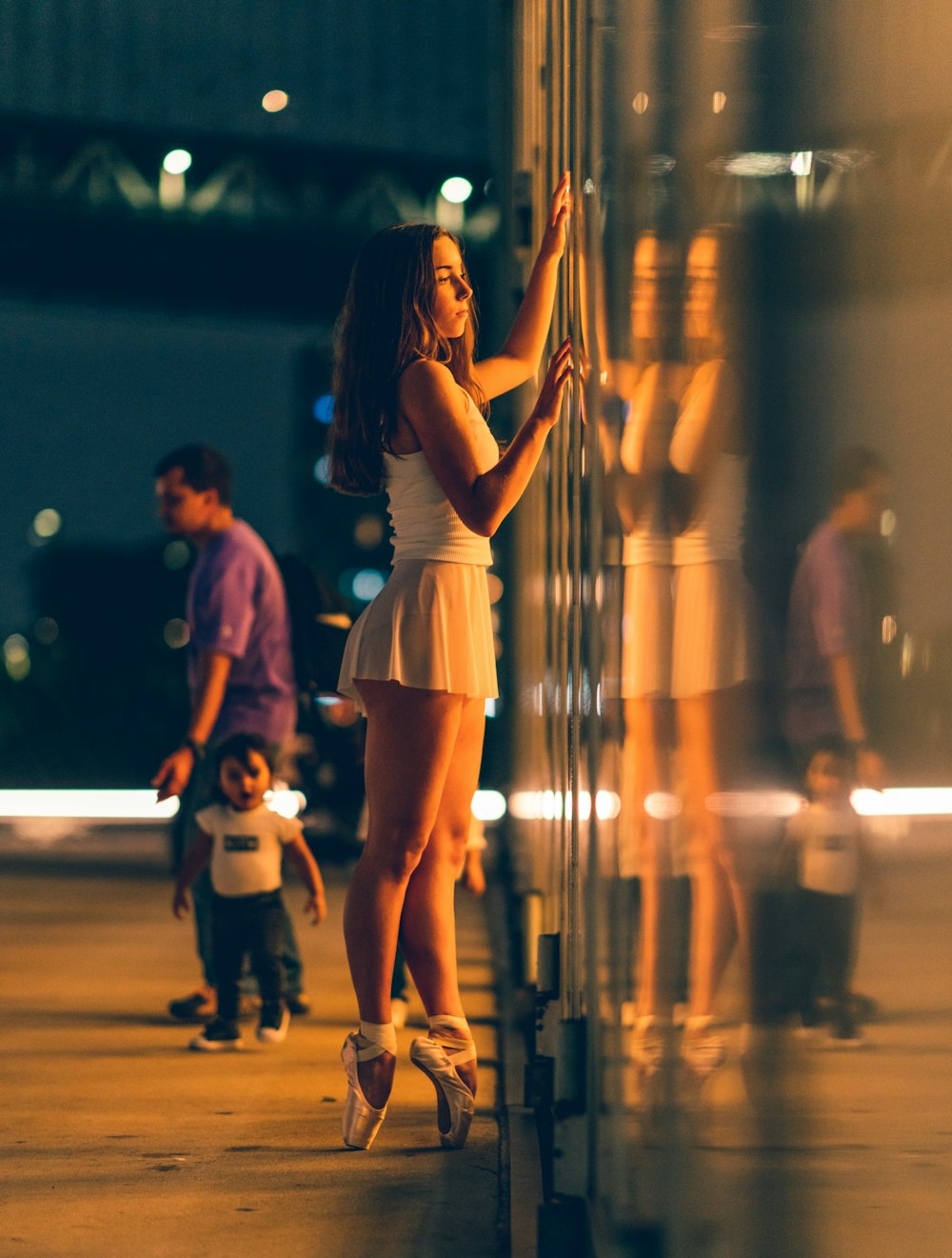 woman wearing ballerina shoes near glass wall