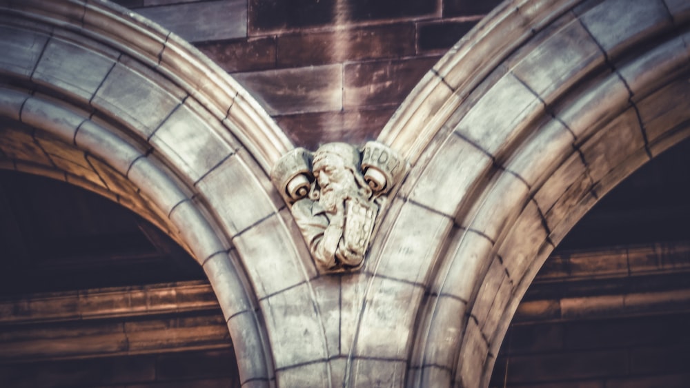 a gargoyle head on the side of a building