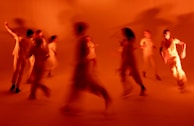 Motion blur of a freestyle twerk move, emphasizing fluidity and energy in a moody studio setting.