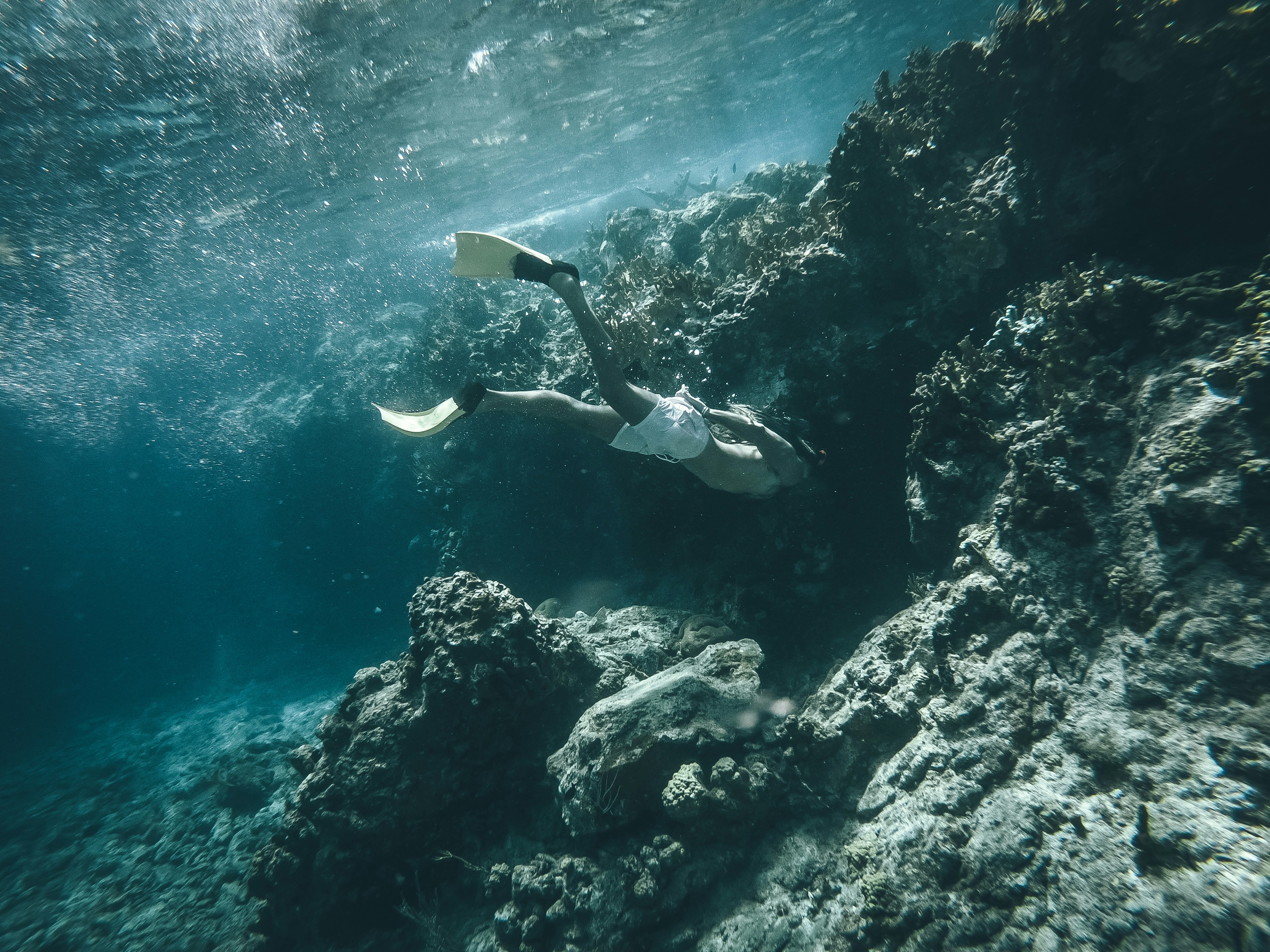 Snorkeler underwater in clear blue ocean water