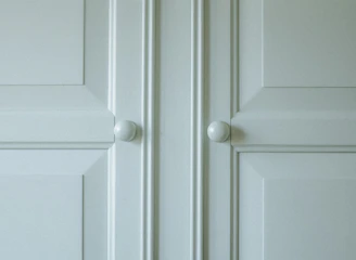 A freshly repaired cabinet door with smooth hinges and polished finish.