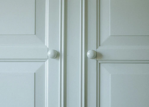A freshly repaired cabinet door with smooth hinges and polished finish.
