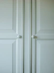 Close-up of elegant classic wood kitchen cabinet doors with detailed craftsmanship.