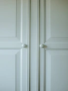 Close-up of elegant classic wood kitchen cabinet doors with detailed craftsmanship.